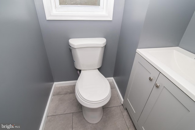 bathroom featuring tile patterned floors, vanity, and toilet