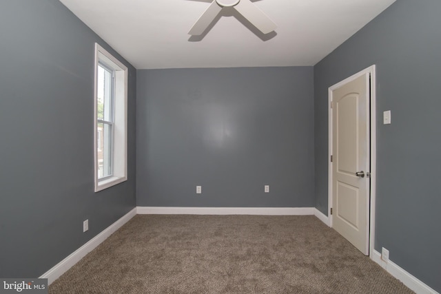 carpeted empty room featuring ceiling fan