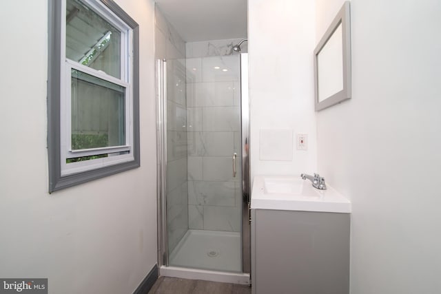 bathroom with walk in shower and vanity