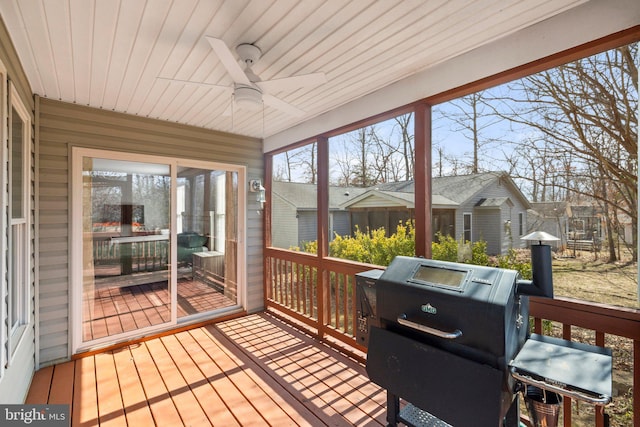 wooden deck featuring a ceiling fan