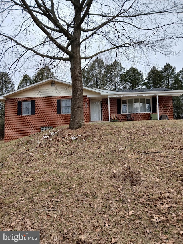single story home featuring brick siding