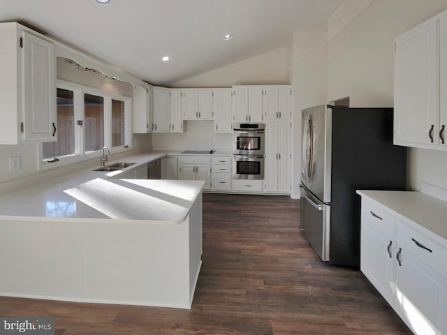 kitchen with sink, stainless steel appliances, dark hardwood / wood-style floors, and white cabinets