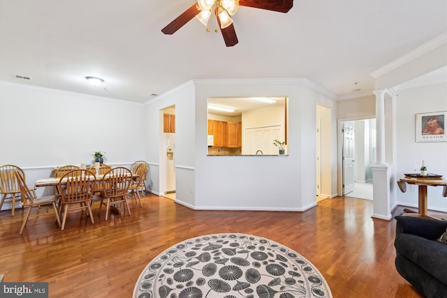 dining space with hardwood / wood-style floors, ornamental molding, decorative columns, and ceiling fan