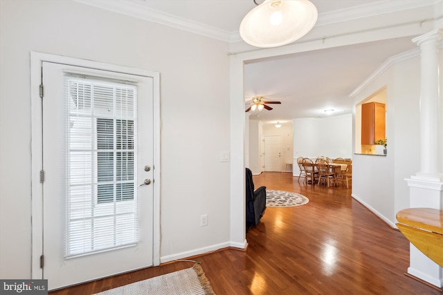 doorway featuring crown molding, ceiling fan, hardwood / wood-style flooring, and ornate columns