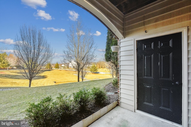 view of exterior entry featuring a yard