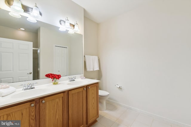 bathroom with vanity, a shower with shower door, and toilet