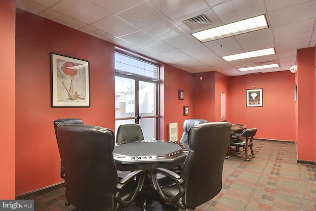 rec room with a drop ceiling and carpet flooring