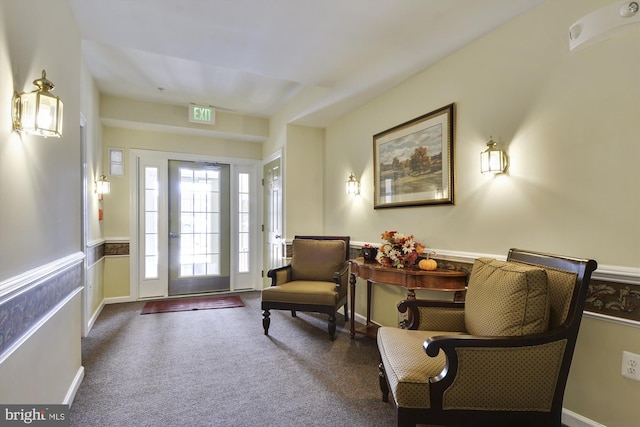 foyer entrance with dark colored carpet