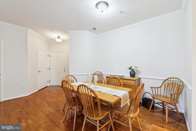 dining space featuring ornamental molding and wood-type flooring