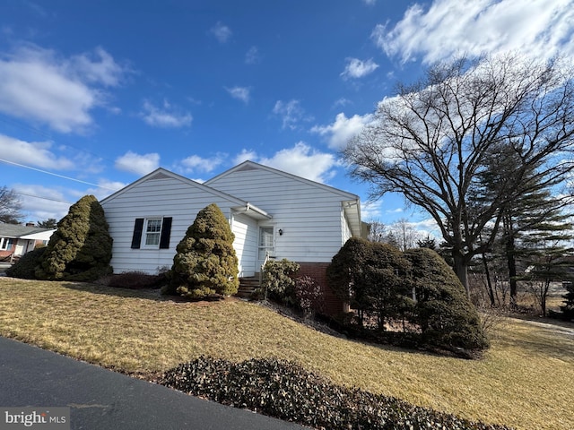 view of property exterior with a lawn