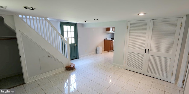 corridor featuring light tile patterned floors