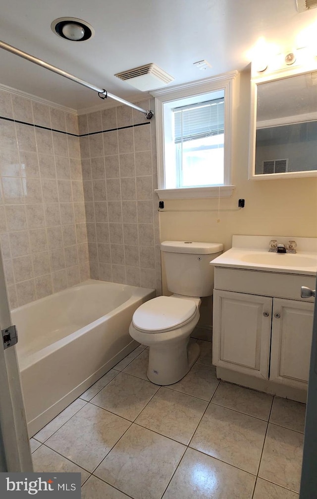 full bathroom featuring tile patterned floors, toilet, tiled shower / bath combo, and vanity