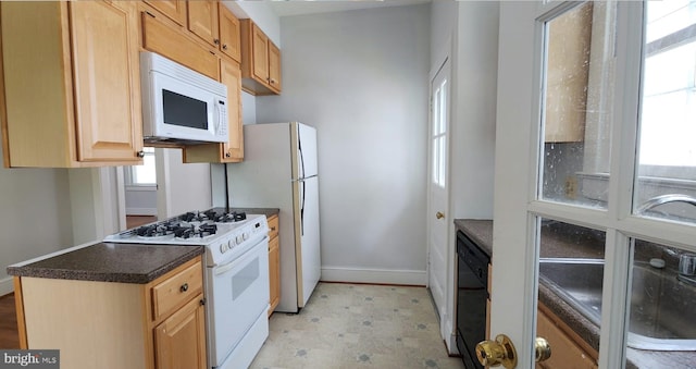 kitchen with white appliances and light brown cabinets