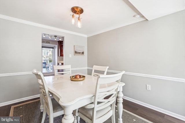 dining area with crown molding, baseboards, and dark wood-type flooring