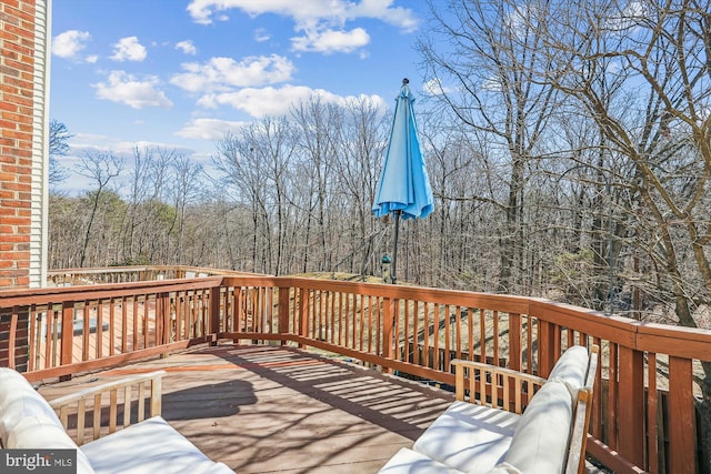 wooden terrace featuring a forest view