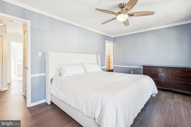 bedroom with ornamental molding, dark wood-style flooring, and baseboards