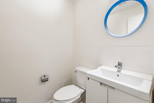 bathroom with visible vents, vanity, and toilet