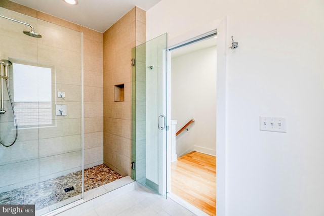 bathroom with a shower with door