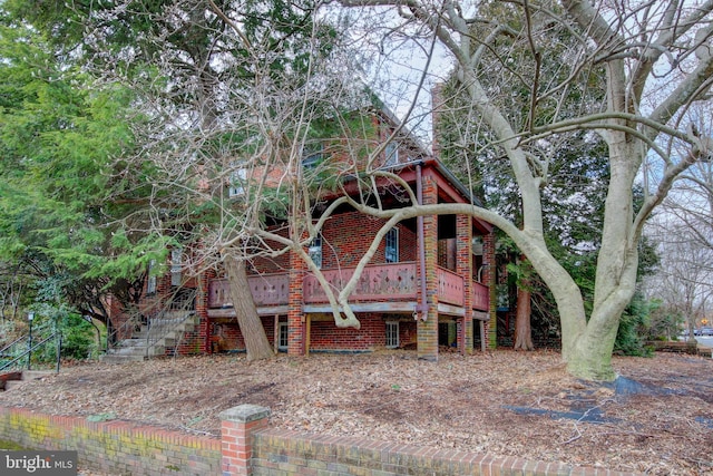 exterior space featuring brick siding and stairway