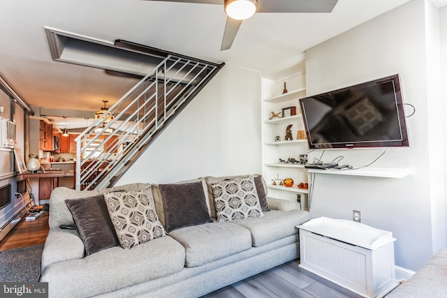 living room with hardwood / wood-style flooring and ceiling fan