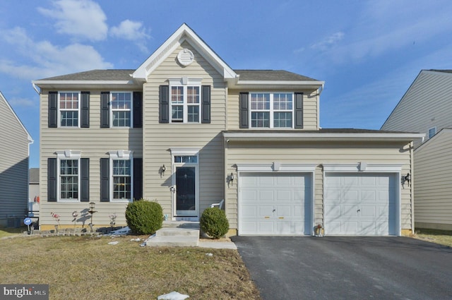 view of front of home featuring a garage and a front lawn