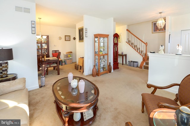 living room featuring light carpet and a notable chandelier