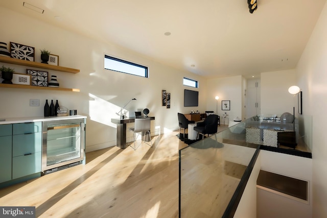 interior space featuring wine cooler and light hardwood / wood-style flooring