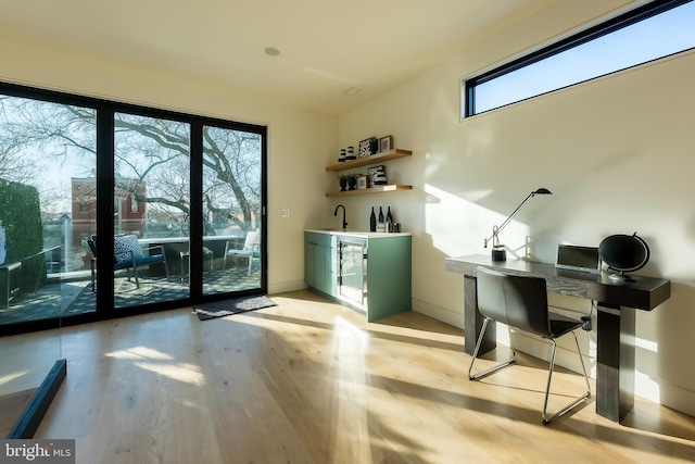 interior space featuring sink, wine cooler, and light hardwood / wood-style floors