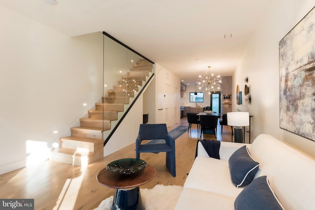 living room featuring an inviting chandelier and light wood-type flooring