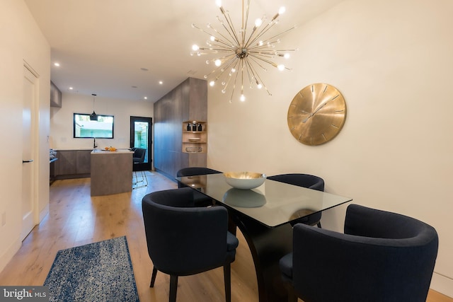 dining room with a notable chandelier and light hardwood / wood-style flooring