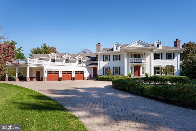 neoclassical / greek revival house with a garage and a balcony