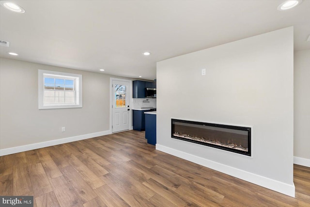 unfurnished living room featuring wood-type flooring