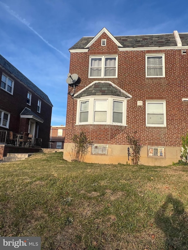 view of property exterior with a lawn