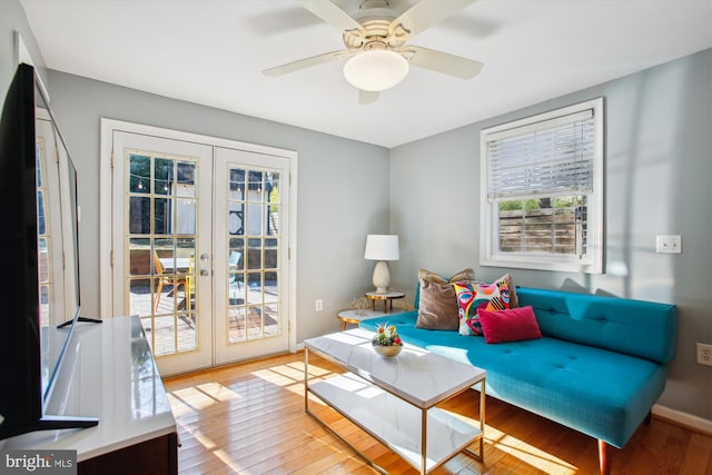 living room with french doors, ceiling fan, and wood-type flooring