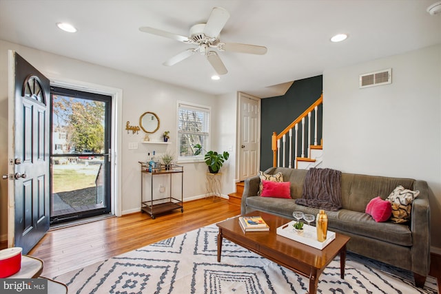 living room with ceiling fan and light hardwood / wood-style floors