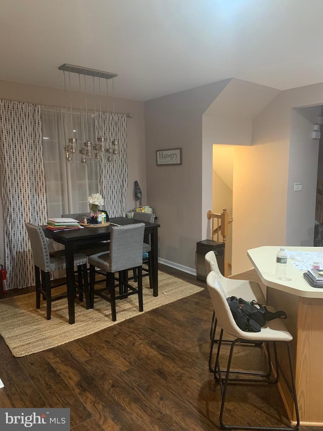 dining area with dark hardwood / wood-style flooring