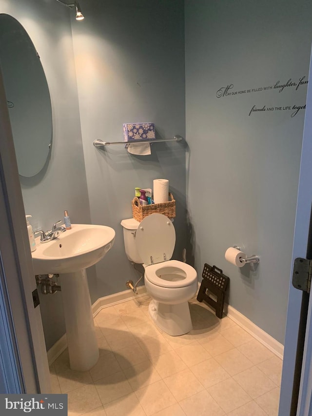 bathroom with tile patterned flooring, sink, and toilet