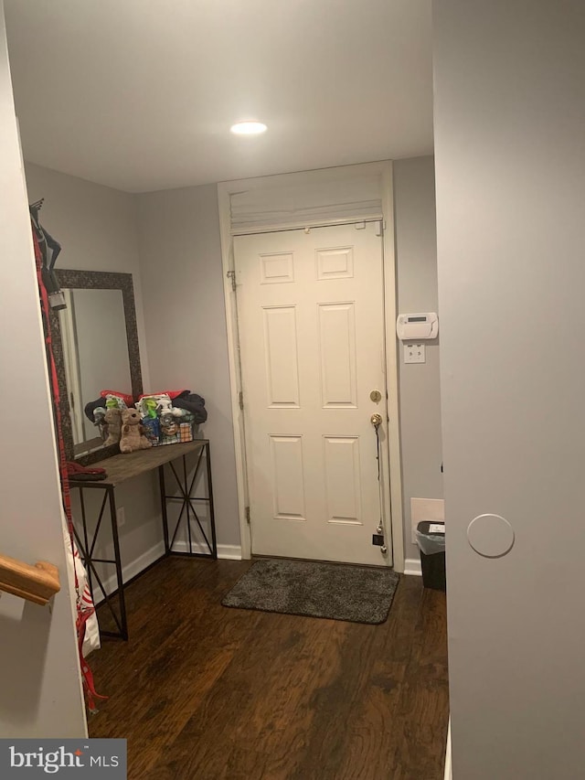 foyer entrance with dark hardwood / wood-style floors