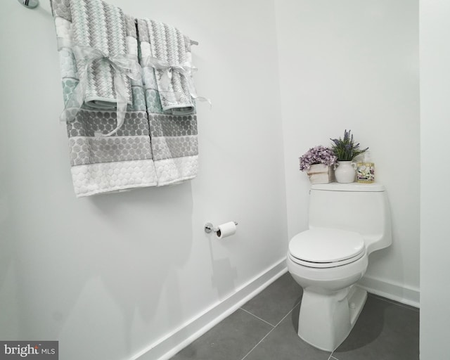 bathroom with tile patterned floors and toilet