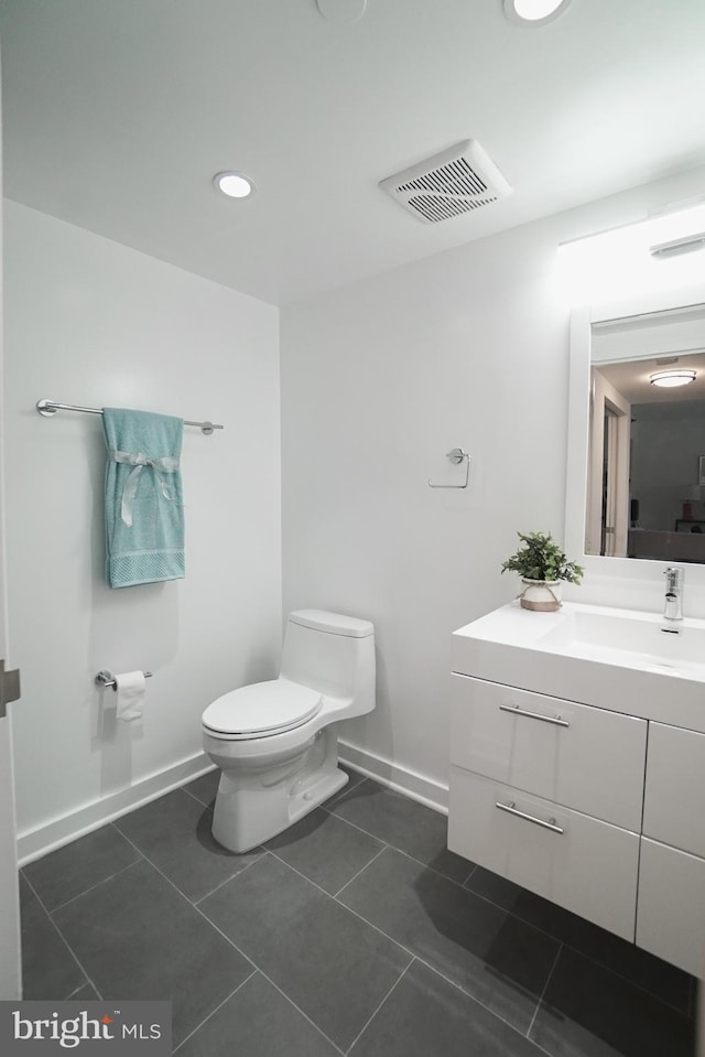 bathroom with tile patterned floors, toilet, and vanity