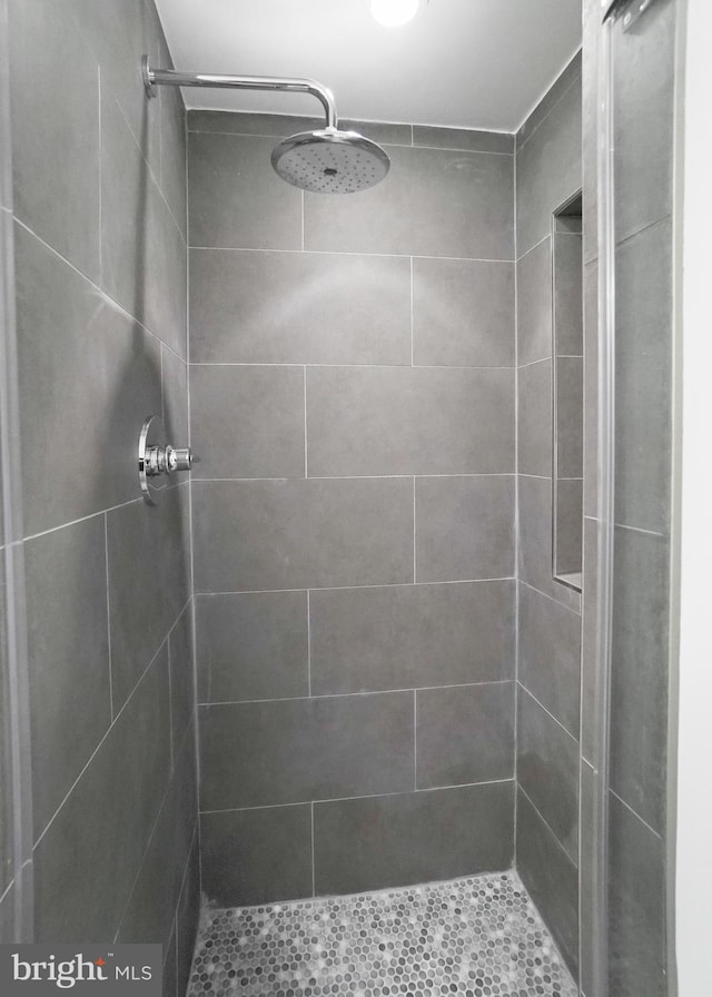 bathroom with tiled shower