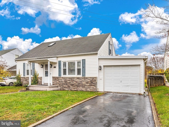 view of front facade with an attached garage, stone siding, aphalt driveway, and a front yard