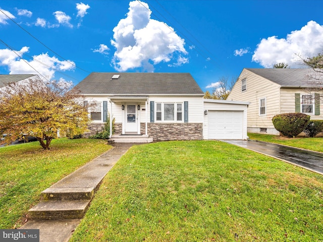 view of front of house with a front yard, stone siding, driveway, and an attached garage