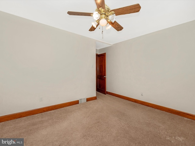 unfurnished room featuring light colored carpet, ceiling fan, visible vents, and baseboards