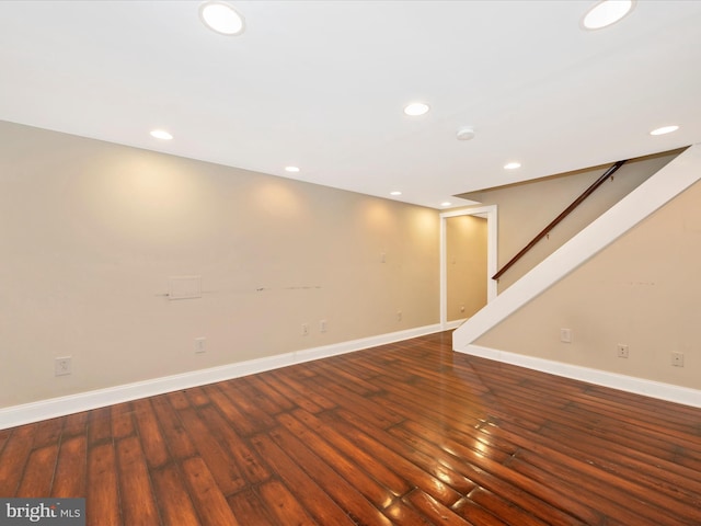 basement with recessed lighting, stairway, baseboards, and hardwood / wood-style flooring