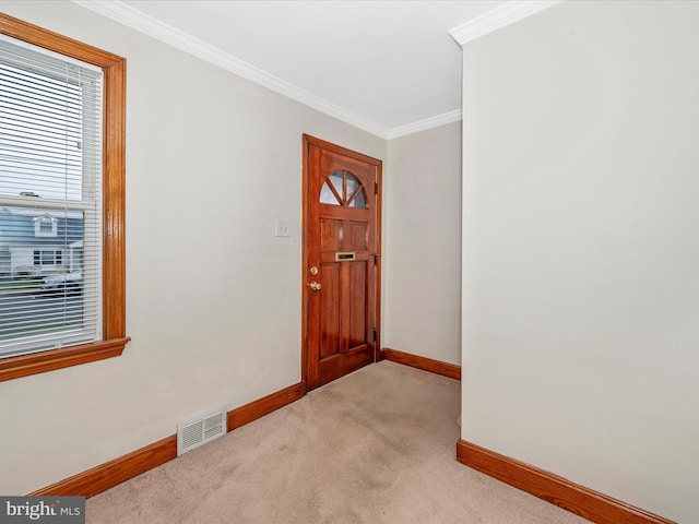 entryway featuring ornamental molding, light colored carpet, visible vents, and baseboards