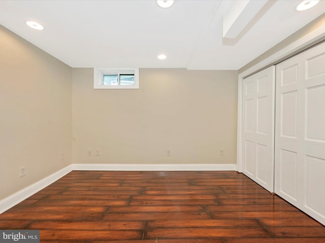 basement featuring baseboards, wood finished floors, and recessed lighting