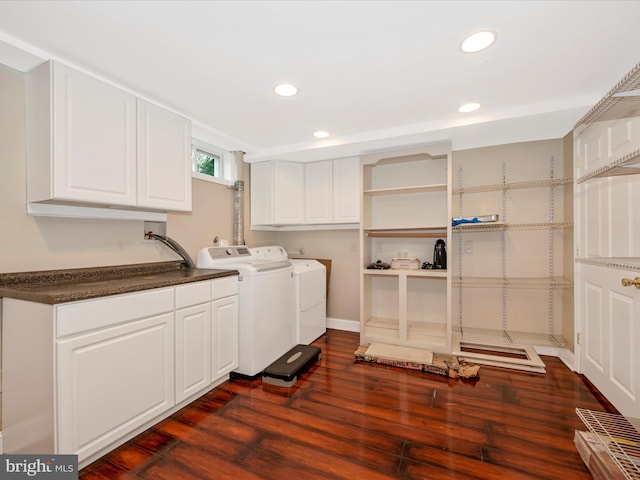 washroom featuring dark wood-type flooring, washing machine and dryer, cabinet space, and recessed lighting