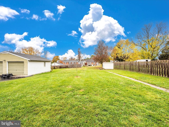 view of yard with an outdoor structure and fence