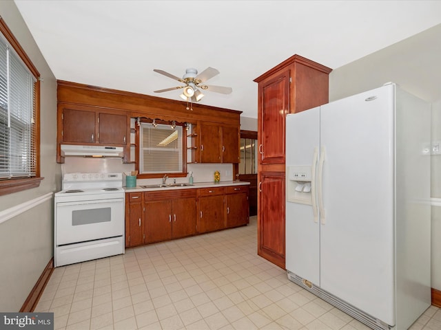 kitchen featuring ceiling fan, under cabinet range hood, white appliances, a sink, and light countertops